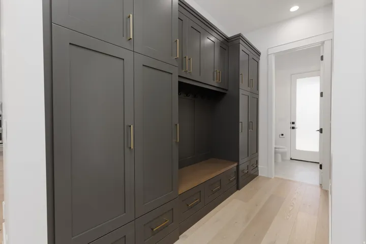 Built-in cabinetry with dark gray finish and gold-toned hardware