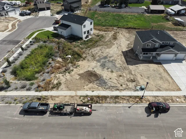 Cleared lot with established street, curb, and sidewalk infrastructure