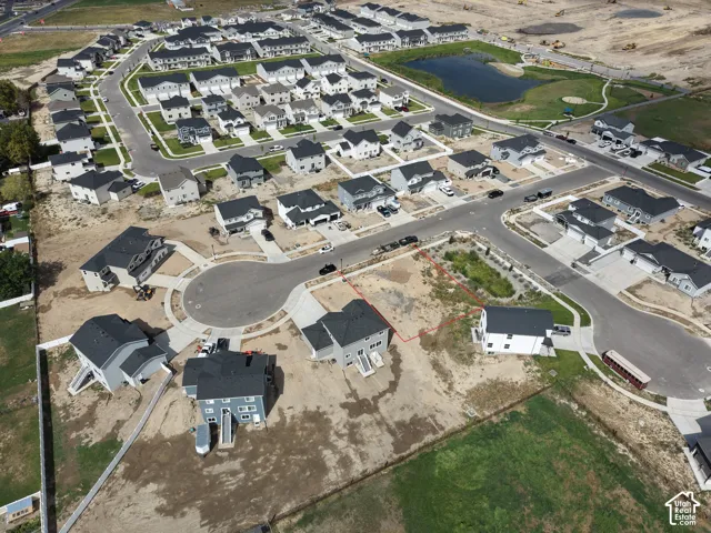 Newly developed neighborhood featuring cul-de-sac streets and a community pond with green space