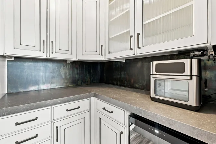 Beautiful pantry with plenty of counter space and cabinetry for storage.