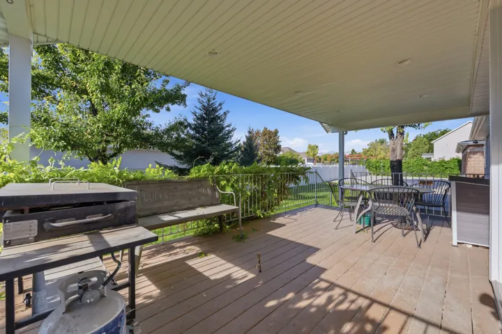 Covered patio with a wood-finish floor and white support columns