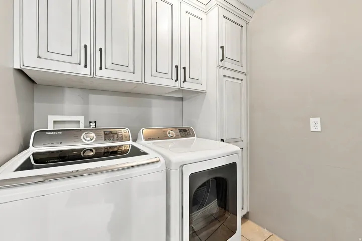 Large upscale laundry room with plenty of storage, right off kitchen.