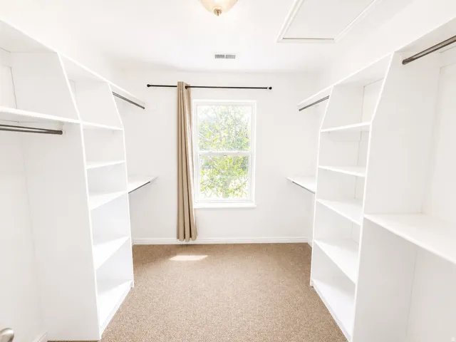 Built-in white shelving with hanging rods