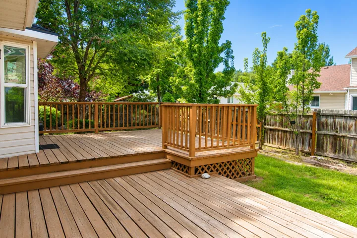 Multi-level wood deck featuring wood railings and lattice skirting