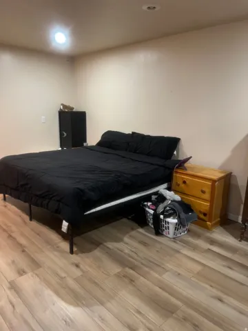 Neutral wall tones with recessed lighting and wood-finish flooring