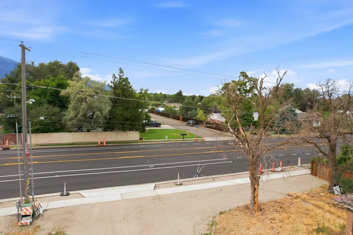 Street-level property with paved road frontage and a concrete sidewalk