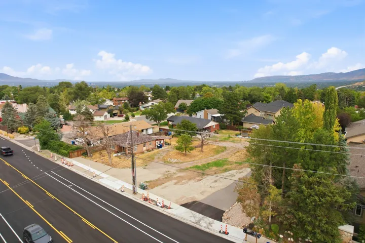 Expansive lot with direct road frontage, established neighborhood setting, and distant mountain scenery
