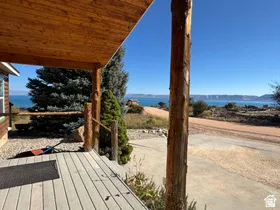 Covered porch with wood-finish ceiling, natural wood posts, and composite decking