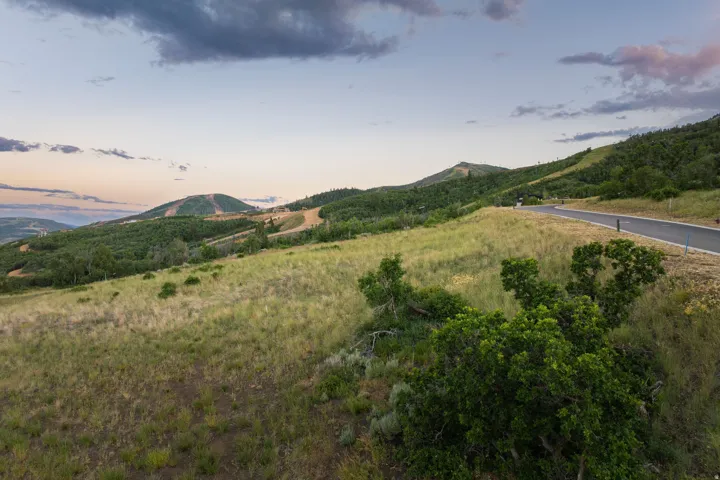 Expansive natural landscape featuring rolling hills and distant mountains
