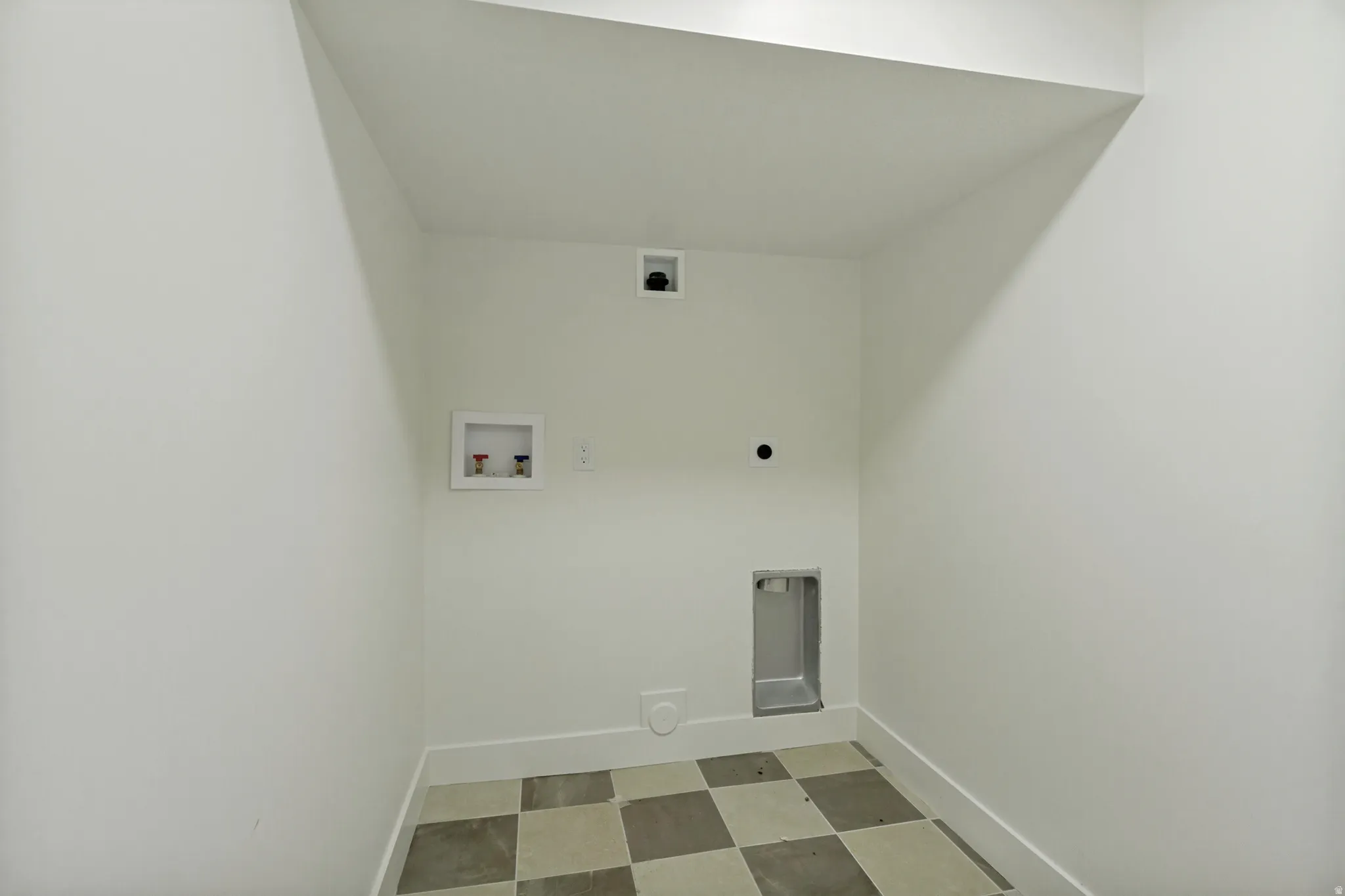 Utility room with checkerboard tile flooring and white walls