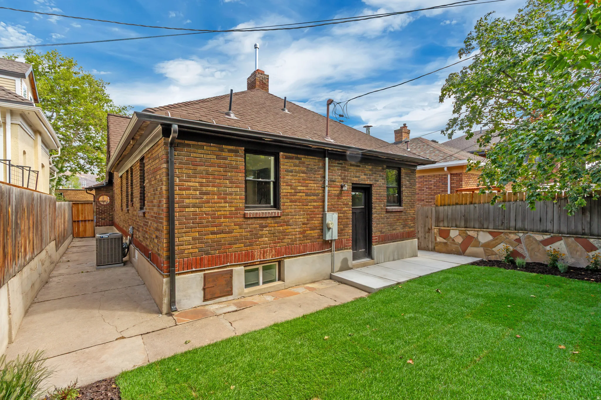 Brick exterior with a gabled roof and dark trim