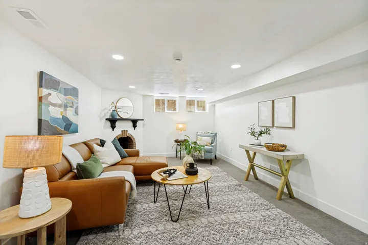 Recessed ceiling lighting, a brick-surround fireplace, and a built-in mantel