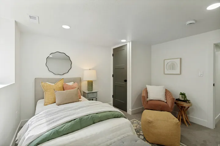 Recessed ceiling lighting, light gray wall paint, dark paneled interior door, and gray carpeted flooring