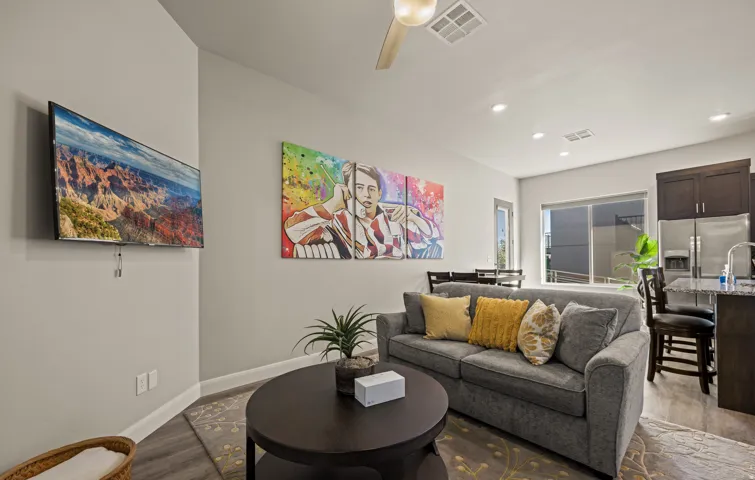 Recessed lighting, wood-finish flooring, ceiling fan, and sliding glass door