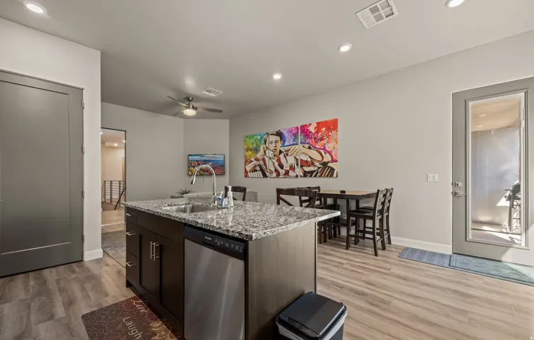 Kitchen island featuring a stainless steel sink and integrated dishwasher