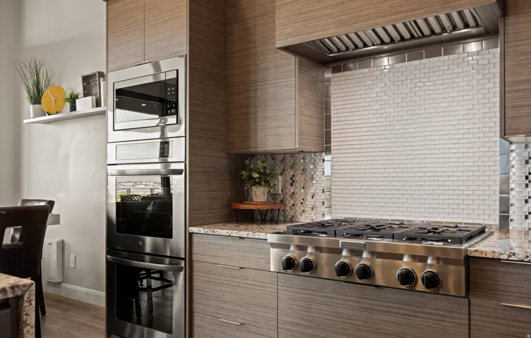 Stainless steel appliance suite featuring a built-in microwave, double oven, and a six-burner gas range