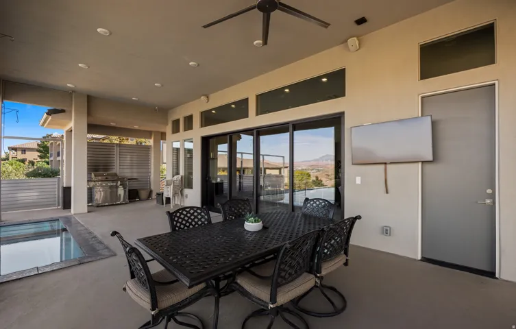 Covered patio with recessed lighting, ceiling fan, built-in outdoor grill, and a plunge pool