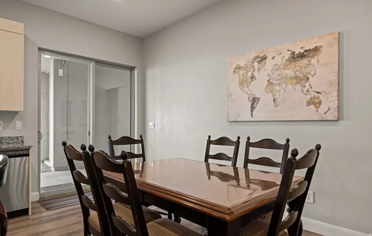 Wood-finish flooring, light gray wall paint, and a sliding glass door