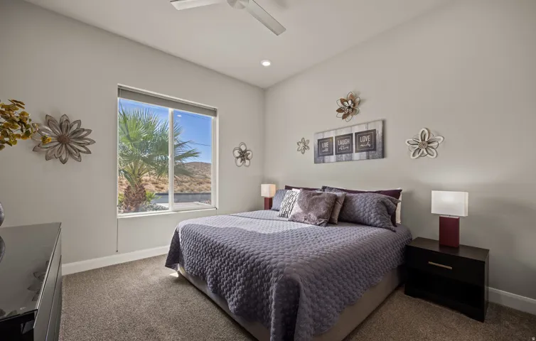 Recessed ceiling lighting, ceiling fan fixture, large window, carpet flooring, and painted walls