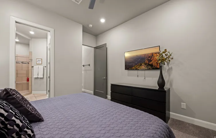 Recessed lighting, ceiling fan, carpet flooring, flat panel door, and tile shower