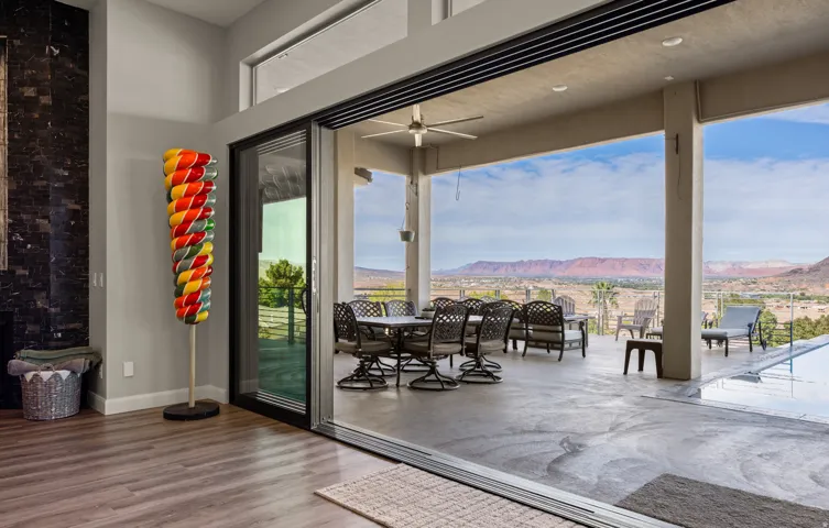 Expansive covered patio with a ceiling fan, recessed lighting, and a durable concrete surface
