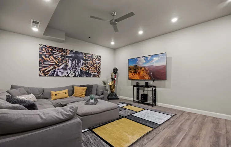Recessed lighting, ceiling fan, wood-finish flooring, and soft wall tones