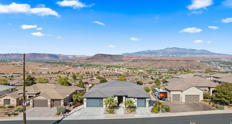 Duplex property featuring modern exterior design, attached garages, and a landscaped front entry
