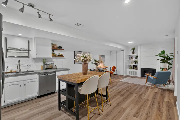 Kitchen featuring white cabinetry, light-toned countertops, and stainless steel appliances