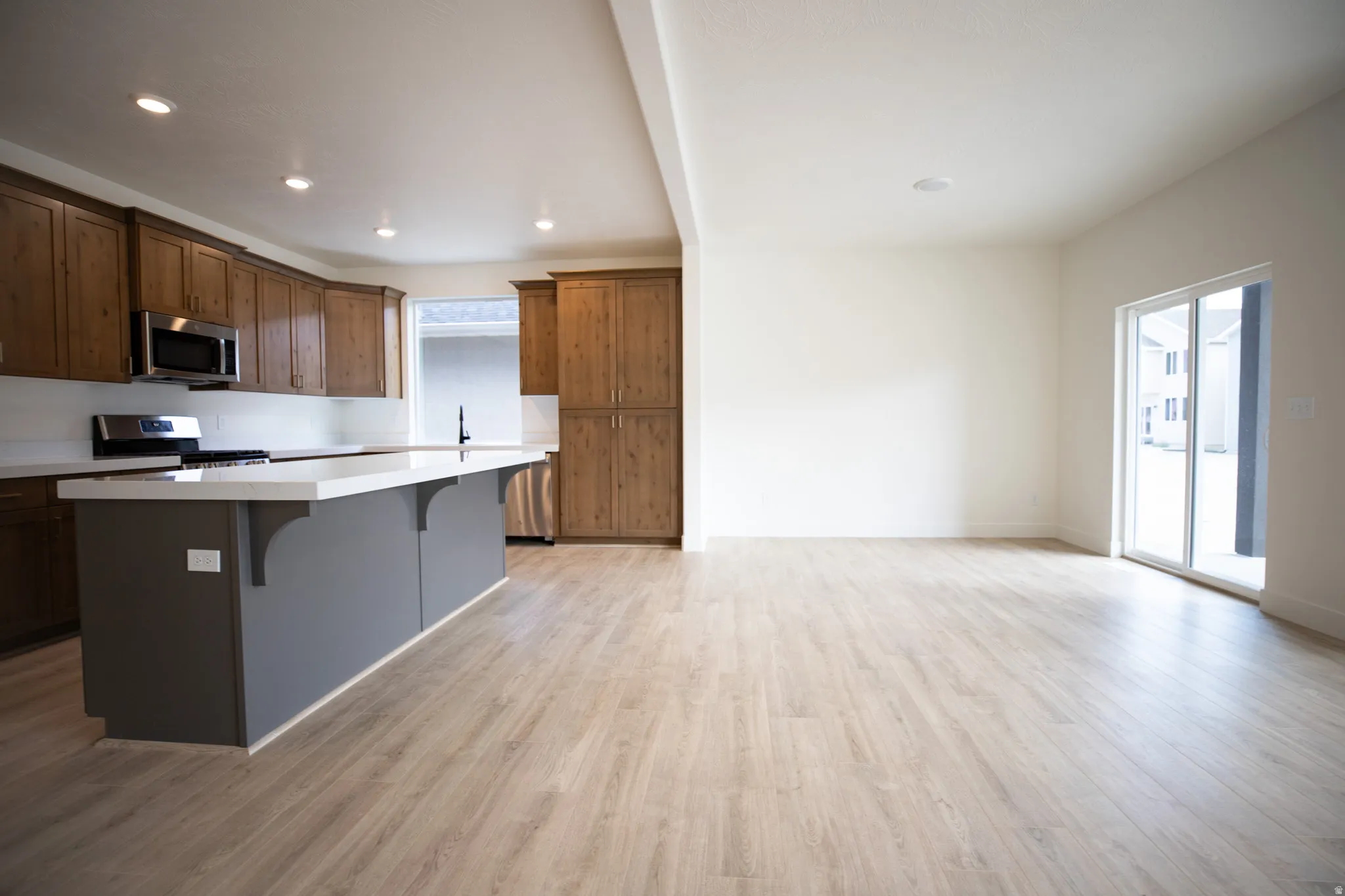Open dining area adjacent to kitchen with sliding glass door to covered back porch