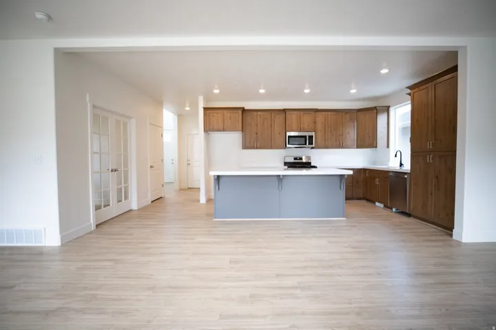 Terrific kitchen with 42" uppers, stained wood cabinets, painted wood island, quartz slab countertops, gas range, microwave, dishwasher and disposal.