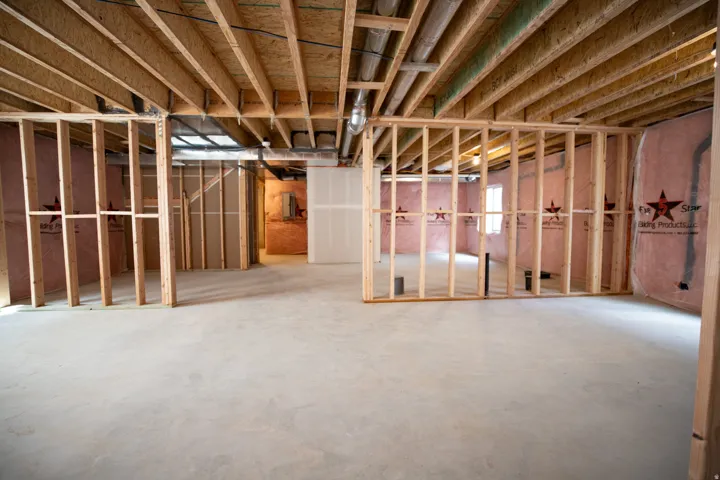 Unfinished basement with potential for large family/game room, full bath, two full bedrooms and two cold storage areas.