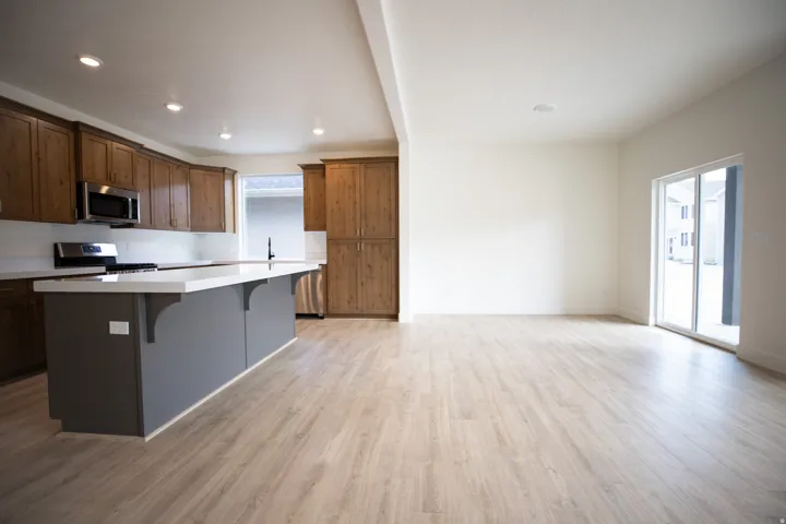 Open dining area adjacent to kitchen with sliding glass door to covered back porch