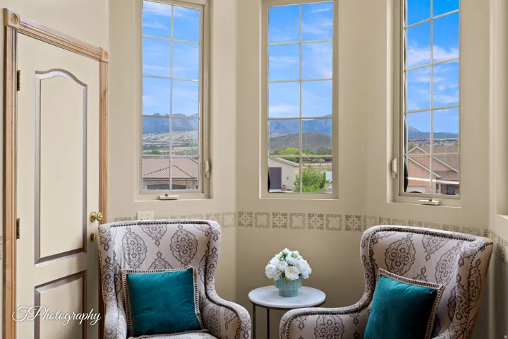 Multiple transom windows with grid panes, decorative wall accent, and a paneled interior door with trim