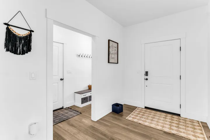 Wood-finish flooring, white walls, and bright white trim
