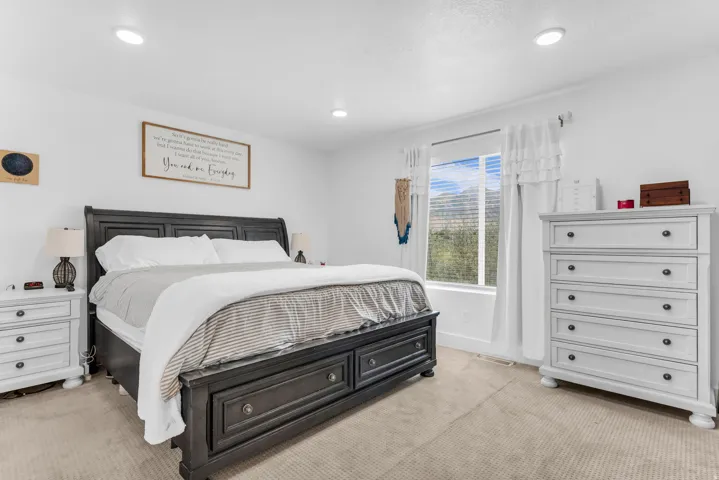 Recessed lighting, wall-to-wall carpeting, and a window with mountain scenery
