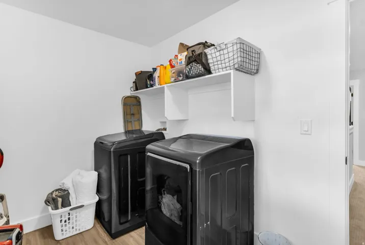 White built-in shelving, wood-finish flooring, and white baseboards