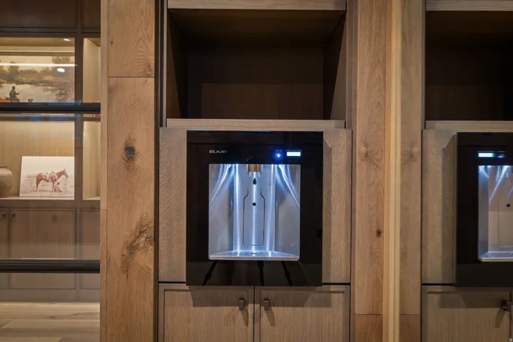 Integrated beverage dispenser within custom wood-finish cabinetry