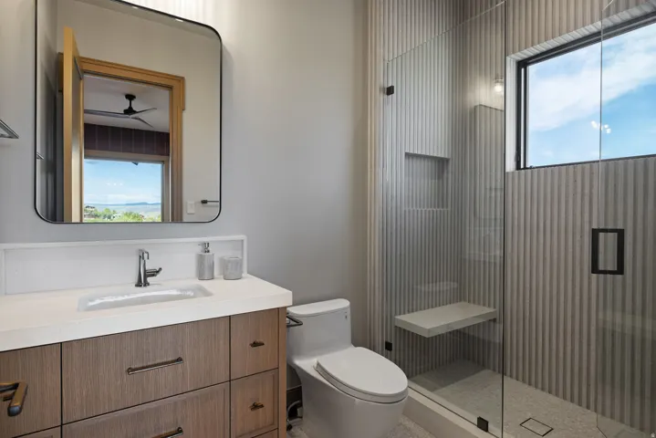 Wood-finish vanity with an integrated rectangular sink and chrome faucet