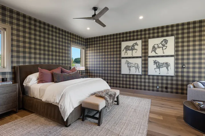 Plaid wall coverings, wood-finish flooring, recessed lighting, and a ceiling fan with integrated lighting