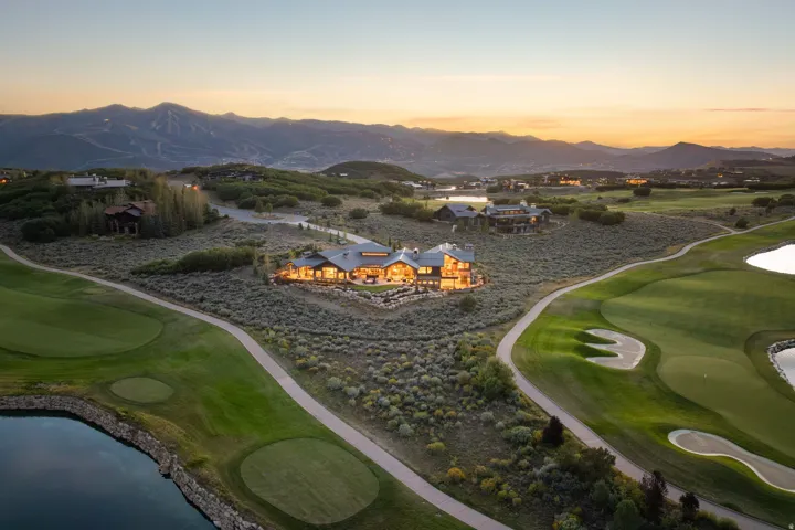 Mountain-side property featuring golf course frontage, manicured greens, and a water feature