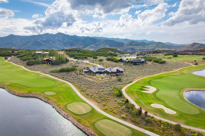 Expansive property featuring a golf course, water elements, and mountain scenery