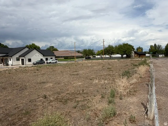 Expansive undeveloped lot with a partial wood fence line