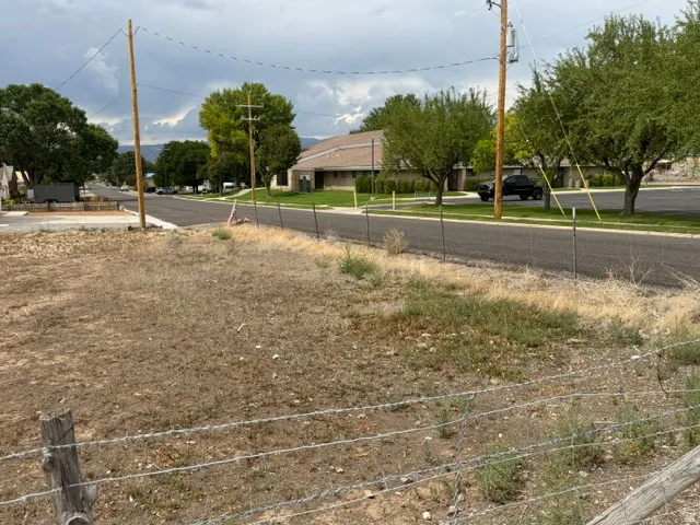 Expansive lot with partial fencing and paved road frontage
