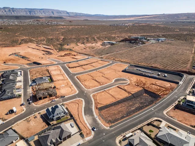 Developing community featuring paved roads, graded lots, and existing residential structures