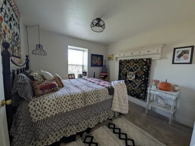 Light-filled interior with neutral wall colors and carpeted flooring
