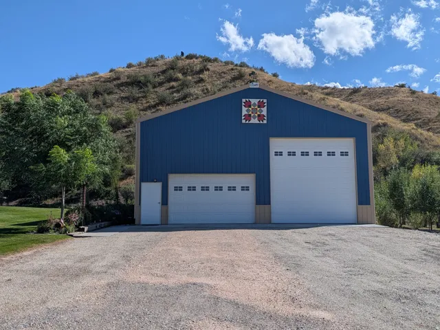 Blue metal siding with a peaked roof