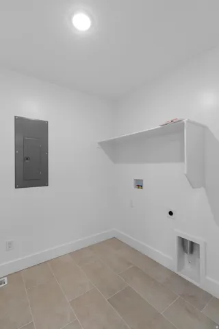 Recessed ceiling lighting, built-in wall shelving, tile flooring, and dedicated appliance hookups