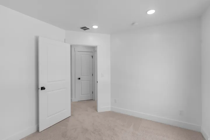 Neutral-toned carpeting with white walls and trim