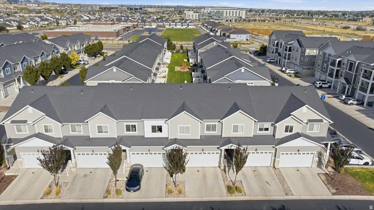 Attached garage, concrete driveway, and front yard landscaping