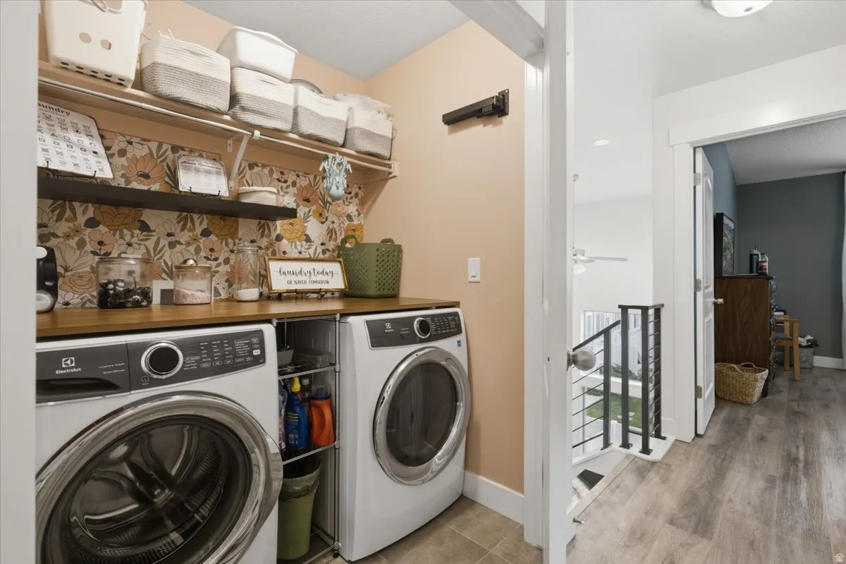 Laundry area with wood-finish countertop, two floating shelves, and tile flooring